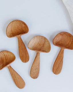 Hand-carved wooden mushroom scoop with rounded cap and smooth handle, photographed on a white background.