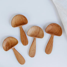 Hand-carved wooden mushroom scoop with rounded cap and smooth handle, photographed on a white background.