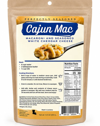 A stand-up pouch of Cajun Mac macaroni and seasoned white cheddar cheese on a plain white background. The package is tan with a large blue brand panel and an image of the cheesy pasta on a spoon.