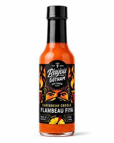 A bottle of Bayou Gotham Caribbean Creole Flambeau Fiya hot sauce, featuring a black cap and a black label with orange and yellow graphics, set against a plain white background.