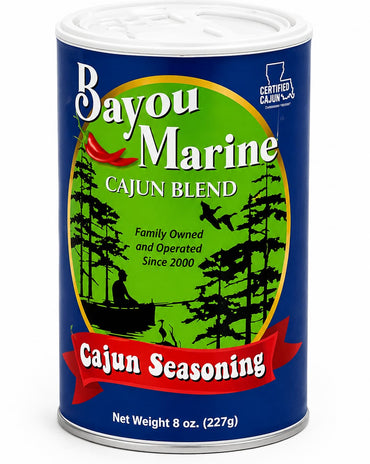 Bayou Marine Cajun Blend seasoning in an 8 oz metal can, featuring a blue label with a green central circle, black tree silhouettes, and a red banner reading 'Cajun Seasoning'.