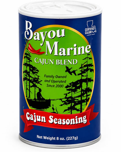 Bayou Marine Cajun Blend seasoning in an 8 oz metal can, featuring a blue label with a green central circle, black tree silhouettes, and a red banner reading 'Cajun Seasoning'.