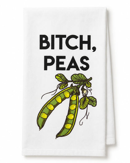 A white kitchen towel featuring the text 'BITCH, PEAS' in bold black letters above an illustration of two green pea pods with yellow peas, shown on a plain white background.
