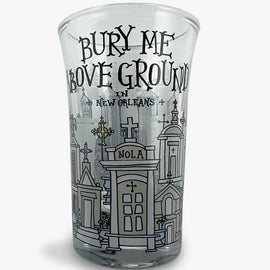 Shot glass with illustrated New Orleans above-ground tombs and the phrase ‘Bury Me Above Ground in New Orleans.’