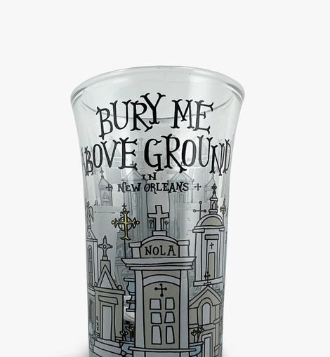 Shot glass with illustrated New Orleans above-ground tombs and the phrase ‘Bury Me Above Ground in New Orleans.’