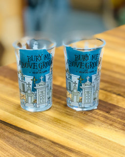 Shot glass with illustrated New Orleans above-ground tombs and the phrase ‘Bury Me Above Ground in New Orleans.’