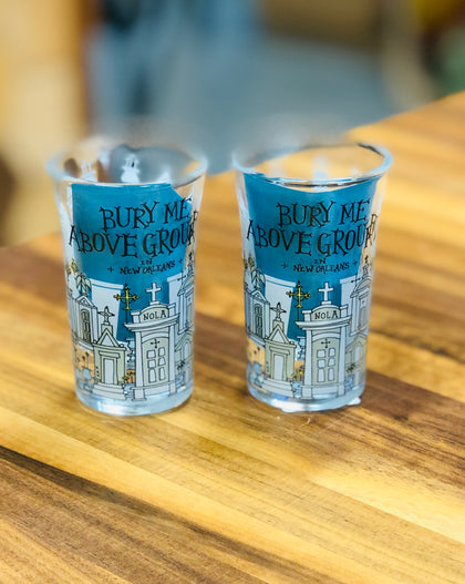 Shot glass with illustrated New Orleans above-ground tombs and the phrase ‘Bury Me Above Ground in New Orleans.’