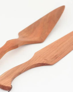 Handcrafted cherry wood cake knife and server set on white background.