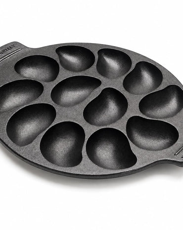 A black cast iron 10 oyster pan with teardrop-shaped cavities, shown on a clean white background. 