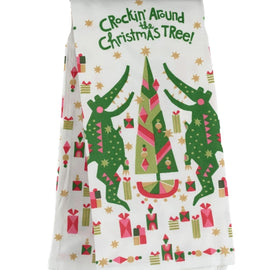 Holiday tea towel featuring dancing alligators around a Christmas tree with colorful gifts and stars.