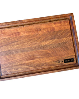 Handcrafted walnut cutting board with deep juice groove and NOLA Boards logo, size 12x18 inches.