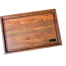 Handcrafted walnut cutting board with deep juice groove and NOLA Boards logo, size 12x18 inches.