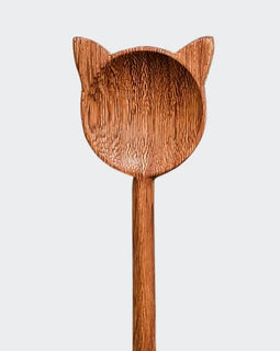 Hand-carved wooden cat stirring spoon with cat-shaped top and curved tail handle on a white background.