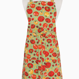 Heirloom tomatoes chef apron with red and yellow tomato pattern on green background, displayed on a mannequin.