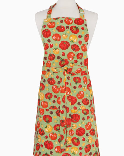 Heirloom tomatoes chef apron with red and yellow tomato pattern on green background, displayed on a mannequin.