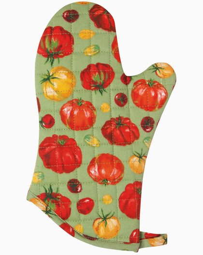 Quilted cotton oven mitt with heirloom tomato print in red and yellow tones hanging on kitchen rack with wooden utensils nearby.