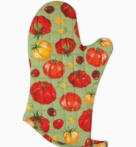 Quilted cotton oven mitt with heirloom tomato print in red and yellow tones hanging on kitchen rack with wooden utensils nearby.