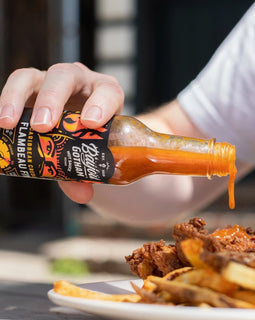 Bottle of Bayou Gotham FLAMBEAU FIYA™ Hot Sauce — sweet-heat Caribbean-style hot sauce made in Louisiana.