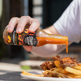 Bottle of Bayou Gotham FLAMBEAU FIYA™ Hot Sauce — sweet-heat Caribbean-style hot sauce made in Louisiana.