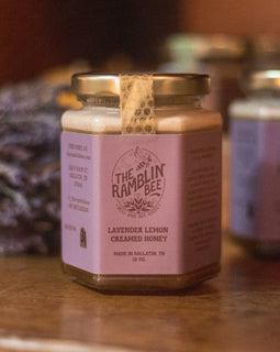 Jar of Lavender Lemon Creamed Honey from The Ramblin’ Bee with lavender in the background.