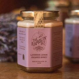 Jar of Lavender Lemon Creamed Honey from The Ramblin’ Bee with lavender in the background.