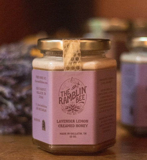 Jar of Lavender Lemon Creamed Honey from The Ramblin’ Bee with lavender in the background.