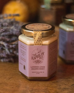 ar of Lavender Lemon Creamed Honey from The Ramblin’ Bee with lavender in the background.