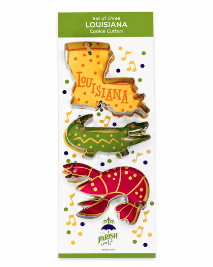 A package of three Louisiana-themed cookie cutters featuring a yellow boot-shaped cutter with 'Louisiana' written on it, a green alligator, and a red crawfish, all on a white backing card with green borders.