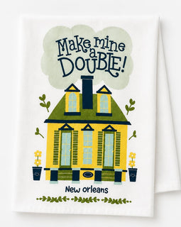 A white kitchen towel featuring a colorful illustration of a yellow house with green trim, the text 'Make mine DOUBLE!' in a cloud above, and 'New orleans' below.