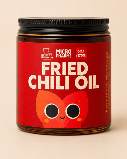 A jar of Micropharmes Fried Chili Oil with a red label and black lid, set against a solid beige background.