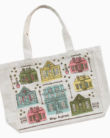 A white canvas tote bag featuring a colorful printed pattern of New Orleans houses and the words 'New Orleans' and 'La Vigne des Champs'.