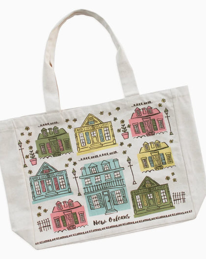 A white canvas tote bag featuring a colorful printed pattern of New Orleans houses and the words 'New Orleans' and 'La Vigne des Champs'.