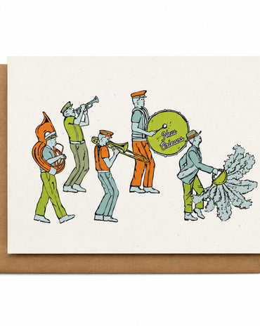 A square cream greeting card with a brown kraft envelope behind it, featuring a retro-style illustration of a marching band with instruments.