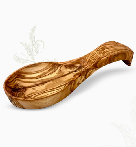 Hand-carved olive wood spoon rest with curved bowl and rich natural grain on a white background.