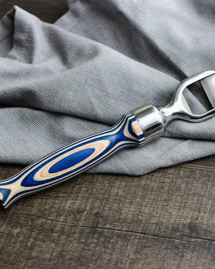 Corkscrew with blue and silver handle on a gray fabric background
