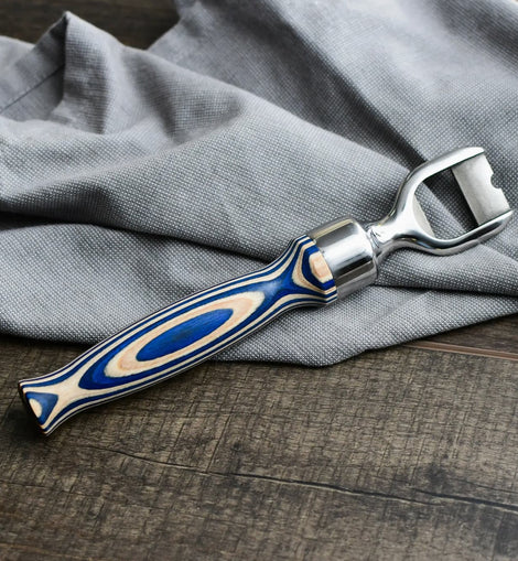 Corkscrew with blue and silver handle on a gray fabric background