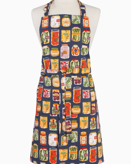 Pickling chef apron featuring colorful preserved vegetable jars on navy striped background with adjustable neck strap and long waist ties.