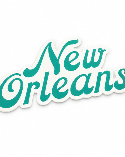 A die-cut vinyl sticker featuring the words 'New Orleans' in a teal cursive script with a white outline, shown on a plain white background.