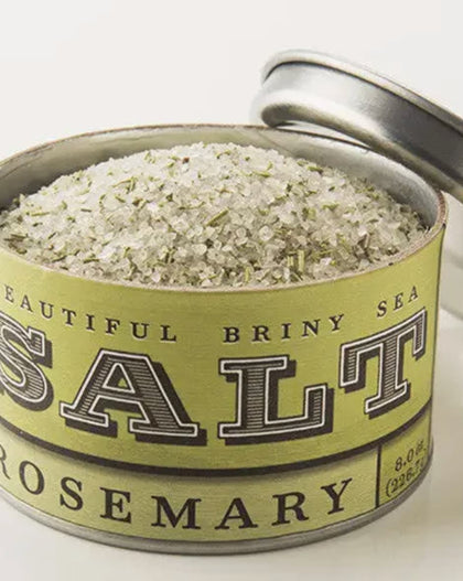 Tin of Beautiful Briny Sea Rosemary Salt with coarse sea salt and rosemary leaves showing.