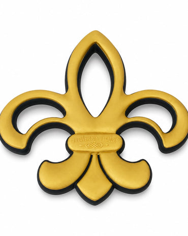 A gold fleur-de-lis metal emblem with a black backing shown on a plain white background.
