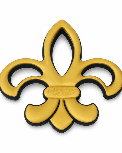 A gold fleur-de-lis metal emblem with a black backing shown on a plain white background.