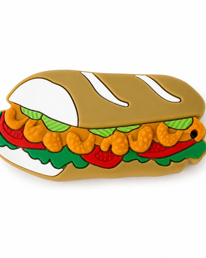 A po boy teether featuring a tan bread bun, orange shrimp, green lettuce, and red tomato slices, shown on a plain white background.