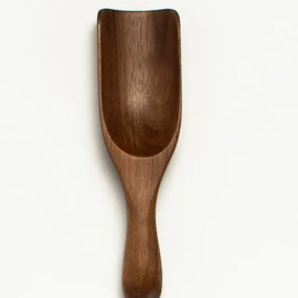 Small 5-inch walnut wood scoop with curved bowl and rounded handle.