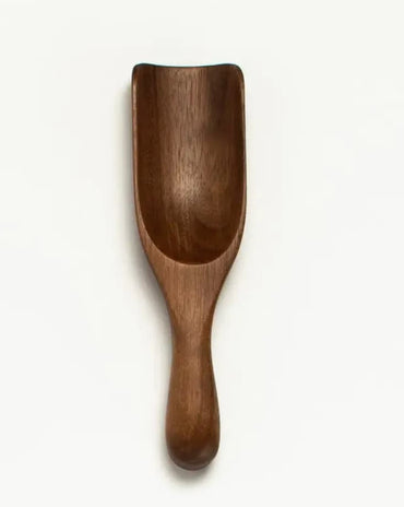 Small 5-inch walnut wood scoop with curved bowl and rounded handle.