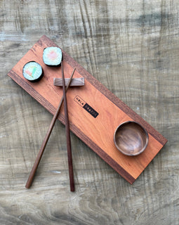 Handcrafted wooden sushi set on Tracks board with mini wooden bowl, wooden chopsticks, and chopstick rest, branded NOLA Boards.