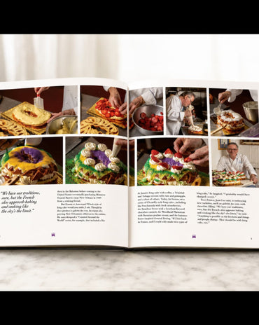 An open cookbook spread displayed on a light marble surface against a white background. The pages feature multiple color food photographs, a quote on the left page, and two columns of text.