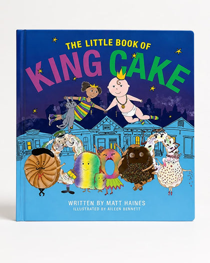 The Little Book of King Cake hardcover book by Matt Haines, illustrated by Allen Bennett, featuring a vibrant blue cover with whimsical cake characters and a house illustration.