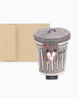 Trash possum mini pop-up greeting card featuring a possum popping out of a trash can with a pull tab that reads “Let’s Get Trashed.”