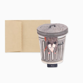 Trash possum mini pop-up greeting card featuring a possum popping out of a trash can with a pull tab that reads “Let’s Get Trashed.”