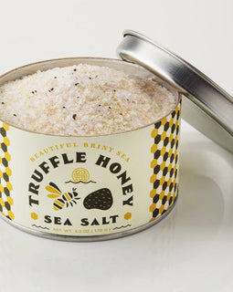 Tin of Beautiful Briny Sea Truffle Honey Sea Salt with visible coarse salt and truffle flecks.